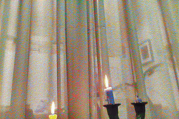 A lit candle reflected in a window, by Douglas Eveleigh