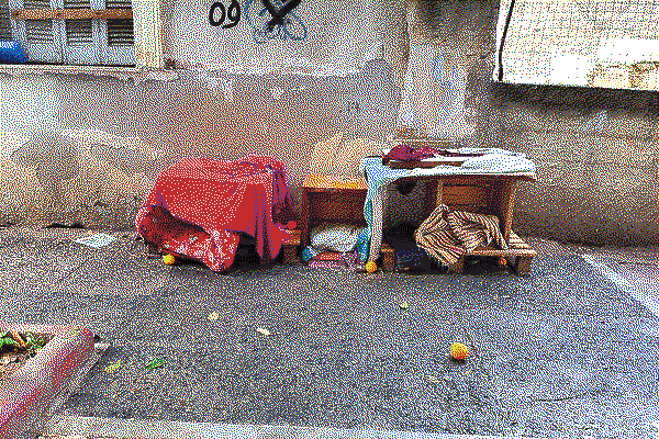 Covered furniture on a pavement, by Douglas Eveleigh